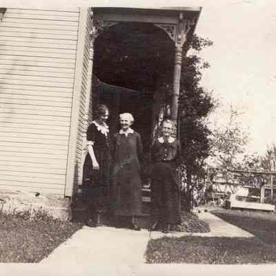 Three Ladies In Front Of House