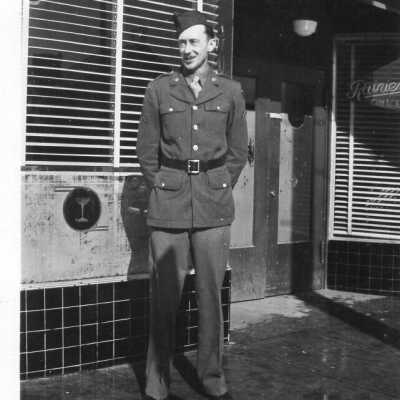 WWII Photo of a Soldier standing in front of a Tap Room