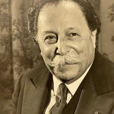 formal B&W portrait of Pierre Monteux with lapel pin