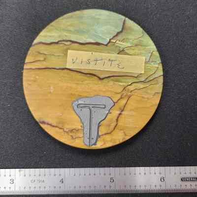 Reverse side of [A], masking tape "Vistite" and old bonding material (JB weld or similar) still present