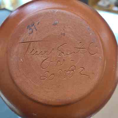 Signed by the artist "Terry Smith" along with an "-N-" denoting their belonging to the Navajo nation along with their tribal roll number "209582"
