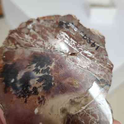 Shows evidence of a previous repair, was broken along the seam between rhyolite exterior and agate center.
