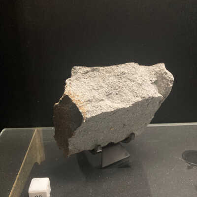 Stony meteorite with fusion crust and rust