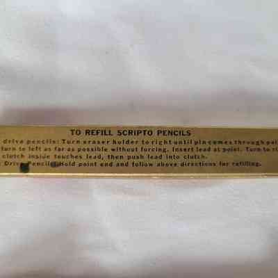 A rectangular box provides instructions for refilling Scripto pencils on its surface in clear text.