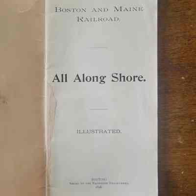 The first page of the booklet, white with black text on a wooden background.