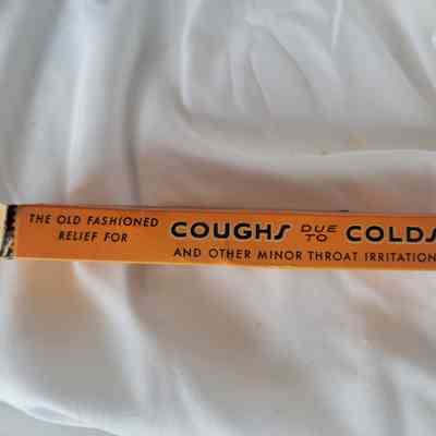 An orange box with text, "The old fashioned relief for coughs due to colds"