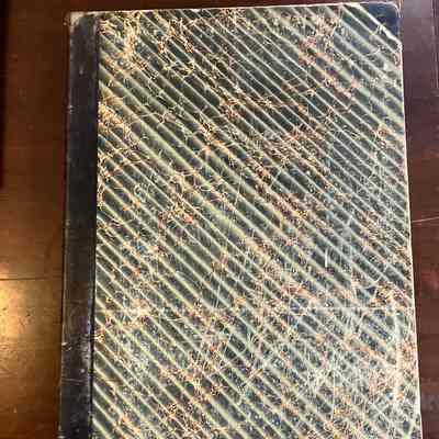 Cover of Willimantic Journal (Bound) 1884-1885: This is a large cardboard-bound book. The cover is black and white striped with red marbling.