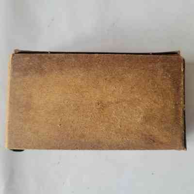 The image shows a rectangular, brown, vintage, cardboard box placed against a plain, white surface.