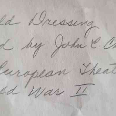 The image displays handwritten text about a field dressing carried by John E. Champe during World War II