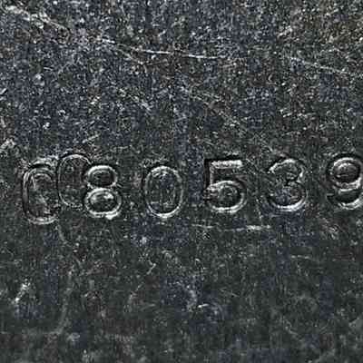 Die Mark #3: The image shows a textured metal surface with the engraved numbers "CC805392" clearly visible.