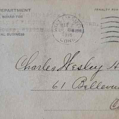 A postcard with a handwritten address and a partially printed, partially stamped return address. Postmark in the upper right.