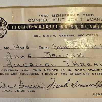 A. Jencik's 1969 Union Card, Signed by Local Secretary Rita Smith: The image depicts a 1969 membership card for the Textile Workers Union of America, issued by the Connecticut Joint Board, featuring the name "Anna Jencik" associated with Local Number 460 in the Department of Synthetics at the American Thread plant. The card verifies that the member is in good standing with dues collected through the check-off system, and it is signed by Rita Smith as the Local Union Secretary and Frank Gencasella as the Manager. The logo of the Textile Workers Union of America (TWUA AFL-CIO) is prominently displayed in the upper left corner, with the name Sol Stetin listed as the General Secretary-Treasurer, conveying a sense of official union documentation from that era.
