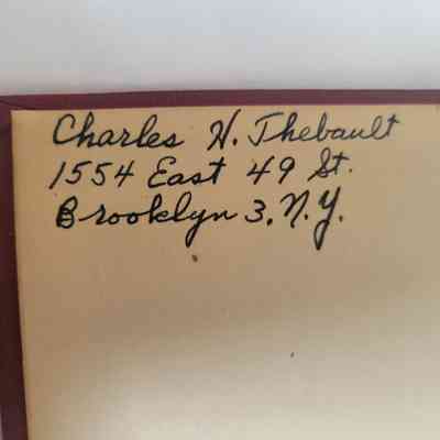 The image shows handwritten text with an address in Brooklyn, New York, on a beige paper background.