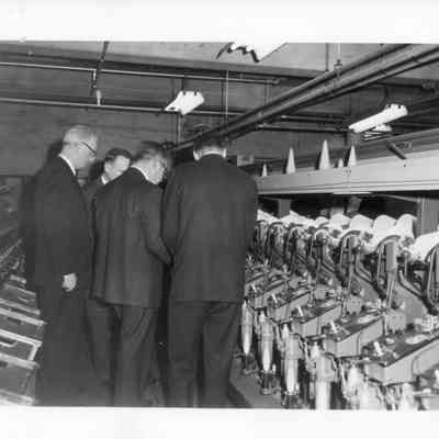 Textile Mill Executives Inspecting Machinery