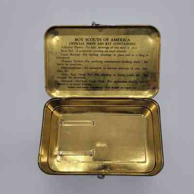 The image shows an open vintage Boy Scouts of America first aid kit with instructions inside the lid.