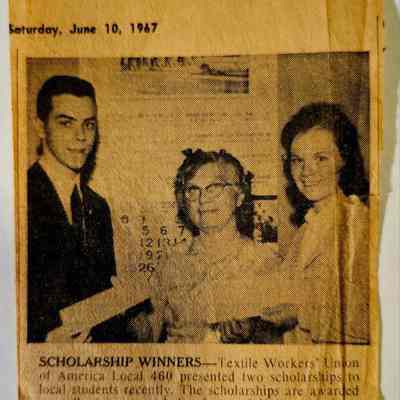 Newspaper Clipping, Willimantic Chronicle: The image is a newspaper clipping dated Saturday, June 10, 1967, featuring a photograph of three people, with an article titled “SCHOLARSHIP WINNERS.” In the photograph, a young man on the left and a young woman on the right stand beside an older woman in the center, who is identified as Mrs. Anna Janosack, the TWUA scholarship chairman. The article explains that the Textile Workers' Union of America Local 460 awarded two scholarships to local students: Joseph LaPlasse and Miss Judith Beauregard. The scholarships are provided annually to children of union members. The photograph captures Mrs. Janosack presenting the awards to the recipients, with the older-style text accompanying the image indicating the community's recognition.