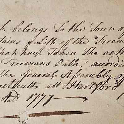Sheet of paper inserted into the beginning of the record book.: The image displays a historical handwritten document from the town of Windham, detailing its ownership and purpose as a record of freemen who have taken an oath of fidelity and the freeman’s oath. The text specifies compliance with the acts of the General Assembly of the State of Connecticut at Hartford in May AD 1777. The script is elegant, reflecting the style of 18th-century penmanship, and the paper shows signs of age, with slight discoloration and edge wear, giving it an authentic, vintage appearance.