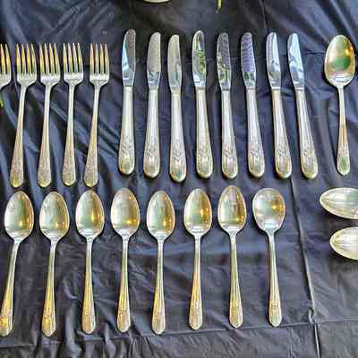 Wm. Rogers Mfg. Co. Silverplate.: From top left: butter knife, dinner forks (7 in.), luncheon knives, tea spoons, salad forks (6 in.), tea spoons again, oval soup spoons (table spoons)