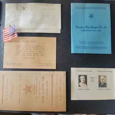 A black scrapbook page with multiple shapes and sizes of ephemera attached.