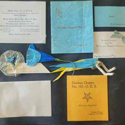 A black scrapbook page with multiple shapes and sizes of ephemera attached.