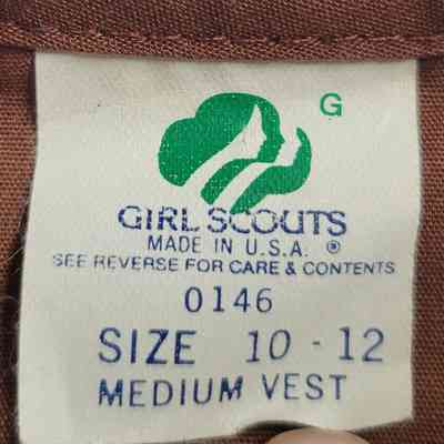 The image shows a Girl Scouts label indicating a medium vest, size 10-12, made in USA