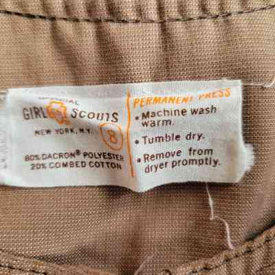 The label has care instructions for a Girl Scouts fabric blend made of polyester and cotton.