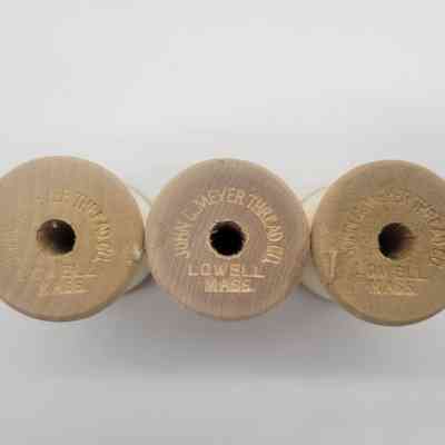 The image shows three wooden thread spools inscribed with "JOHN C. MEYER THREAD, LOWELL MASS."