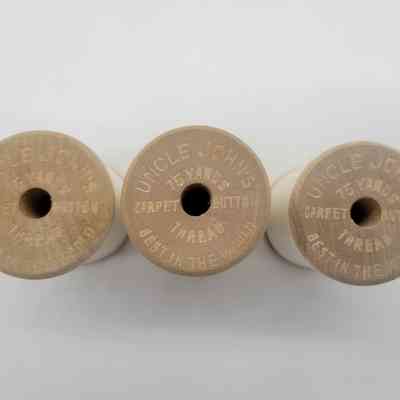 Three wooden spools of Uncle John's thread, labeled as "Best in the World," are shown.