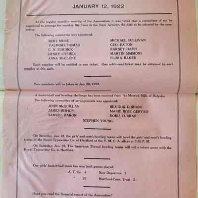 A pink piece of paper with large black lettering. The paper is creased horizontally in the middle.