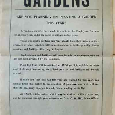 A pale green piece of paper with large black lettering. The paper is creased horizontally in the middle and the edges are yellowed.