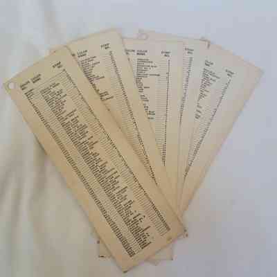 The image shows five cream-colored cards displaying lists of color names and corresponding strip numbers, fanned out