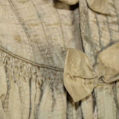 Catridge pleating at waist, front of dress with bow detail