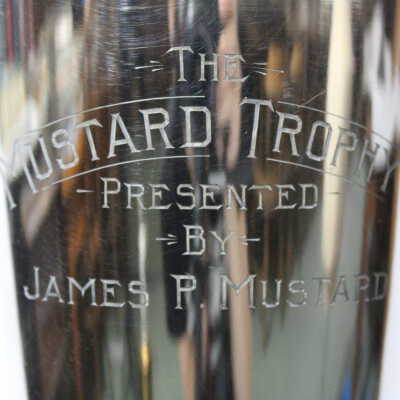 Close up of Back of Trophy: Reads "The Mustard Trophy Presented by James P. Mustard"