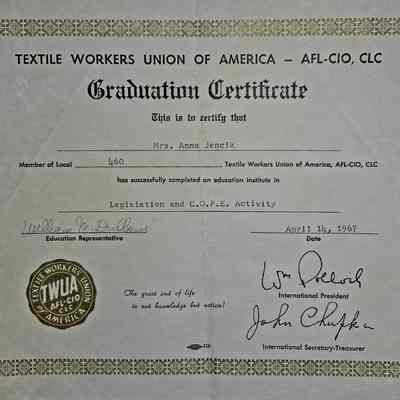 Graduation Certificate: The image displays a Graduation Certificate from the Textile Workers Union of America, AFL-CIO, CLC, awarded to Mrs. Anna Jencik, a member of Local 460. The certificate verifies her successful completion of an educational course in Legislation and C.O.P.E. Activity. It is dated April 14, 1967, and features signatures from William Pollard, International President, and John Chupka, International Secretary-Treasurer, as well as an Education Representative named William M. DuBose. Additionally, the certificate is adorned with a border design and features the Textile Workers Union emblem in a gold seal. The quote, "The great end of life is not knowledge but action!" is prominently displayed on the certificate.