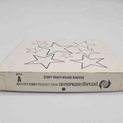 The image shows a vintage box labeled "Star Ready-Wound Bobbins" with star designs on its top.