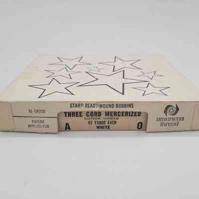 The image shows a box labeled "Three Cord Mercerized" with stars printed on it.