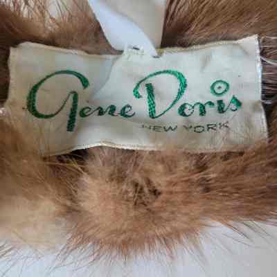 The image shows a "Gene Doris New York" clothing label sewn onto a fur garment.