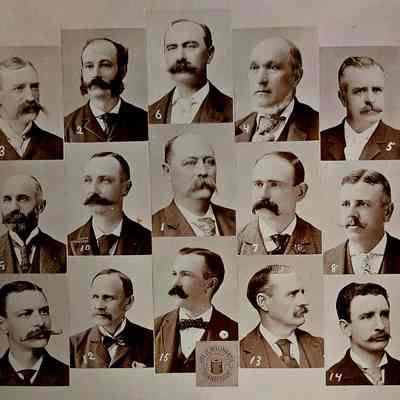 Photo alone: The image displays a compilation of fifteen black-and-white portraits of men, each adorned with a unique style of mustache, ranging from handlebar to full beards. Each image is numbered and arranged in a grid format. The men are dressed in formal attire typical of the late 19th to early 20th century, featuring suits with ties or bow ties. The presence of different facial hairstyles highlights the societal trends of the period. The background is plain, directing all focus towards the distinguishing features of the subjects. Additionally, there is a circular seal at the bottom indicating “City of Willimantic, Connecticut,” suggesting the possible geographic or organizational context of the portraits.