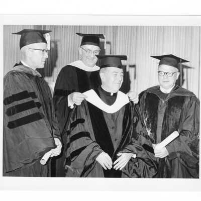 William F. Maloney, S.J., with three honorary degree recipients, Edward B. Bunn, S.J. (Chancellor of Georgetown University), Robert G. Dunlop, and Stuart T. Saunders during 1965 graduation/commencement.