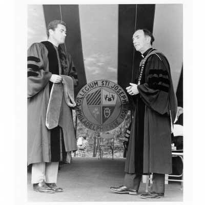 Terrence Toland, S.J., conferring honorary degree on U.S. Representative William J. Green III (class 1960) during 1976 graduation/commencement.