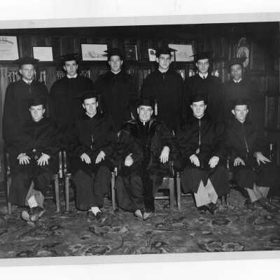 Members of Alpha Sigma Nu Honor Society in cap and gown, including J. Jenkins, L. Maguire, J. O'Donnell, W. Maher, J. Horstmann, L. Pierce, J. Gilliland, P. Byrne, J. Clemmens, E. Gibson, John J. Long, S.J.