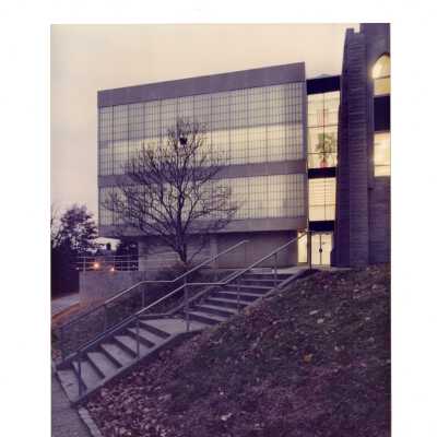 Exterior view of new wing or addition of Drexel Library at night with lights on inside.
