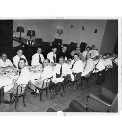 Alumni reunion of class of 1931, held May 1951. Alumni are shown eating dinner at long table with Joseph S. Hogan, S.J.