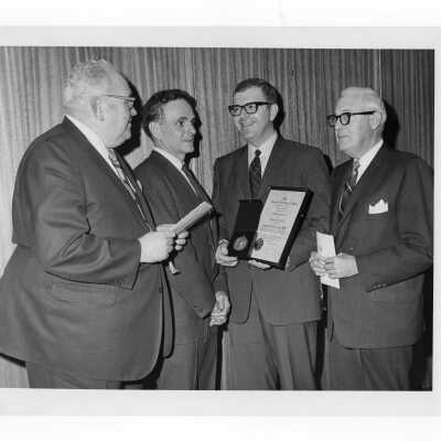 Shaffrey award recipient, Dr. Joseph T. English, showing medal and certificate to three others, April 9, 1969.