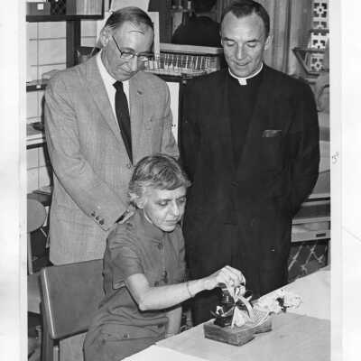 Josephine Savaro (Librarian) with Terrence Toland, S.J., and another individual.