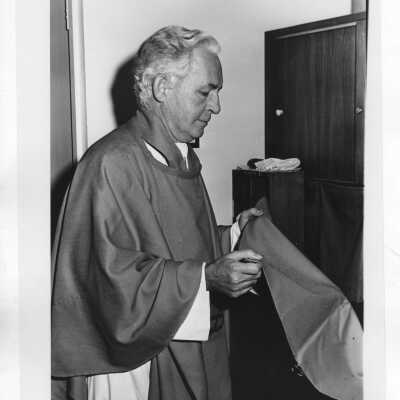 Francis J. Emory, S.J.: Faculty, Theology; Chaplain, especially for the Evening Division. Fr. Emory is shown in vestments in a sacristy, either before or after a Mass.