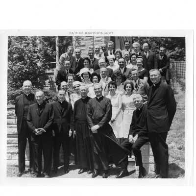 Alumni and spouses from class of 1940 at reunion, held June 5, 1965. Group photo taken outside Campion Center and includes Matthew Sullivan, S.J., Michael Smith, S.J., and William F. Maloney, S.J.