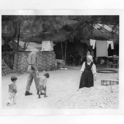 U.S. soldier with two Vietnamese orphans and Vietnamese nun.