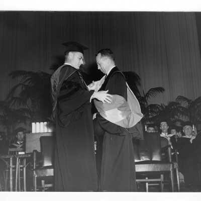 Edward G. Jacklin, S.J., bestowing honorary degree on Charles W. Perelle during 1952 graduation/commencement ceremony.