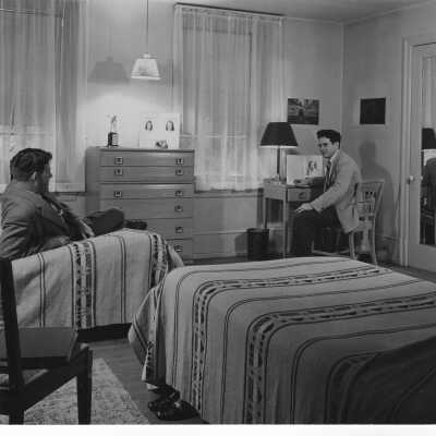Two students in dormitory room in student residence.